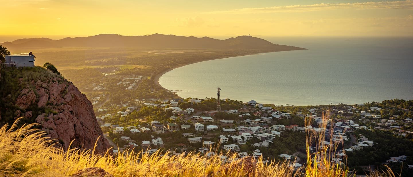Aerial view of the Townsville coastline at sunset, looking across the city to Cleveland Bay