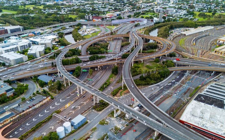 A multi level road interchange carrying traffic over a highway